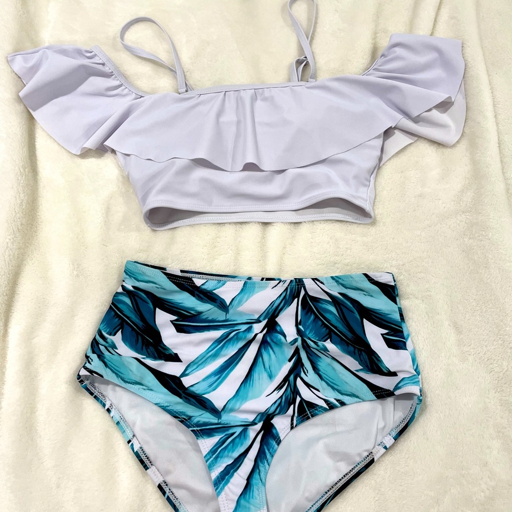 2- piece bathing suit, white ruffle off shoulder top with tropical bottoms.